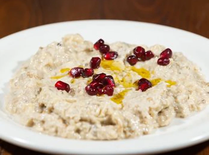 Baba Ghannouge with pomegranate seeds and olive oil
